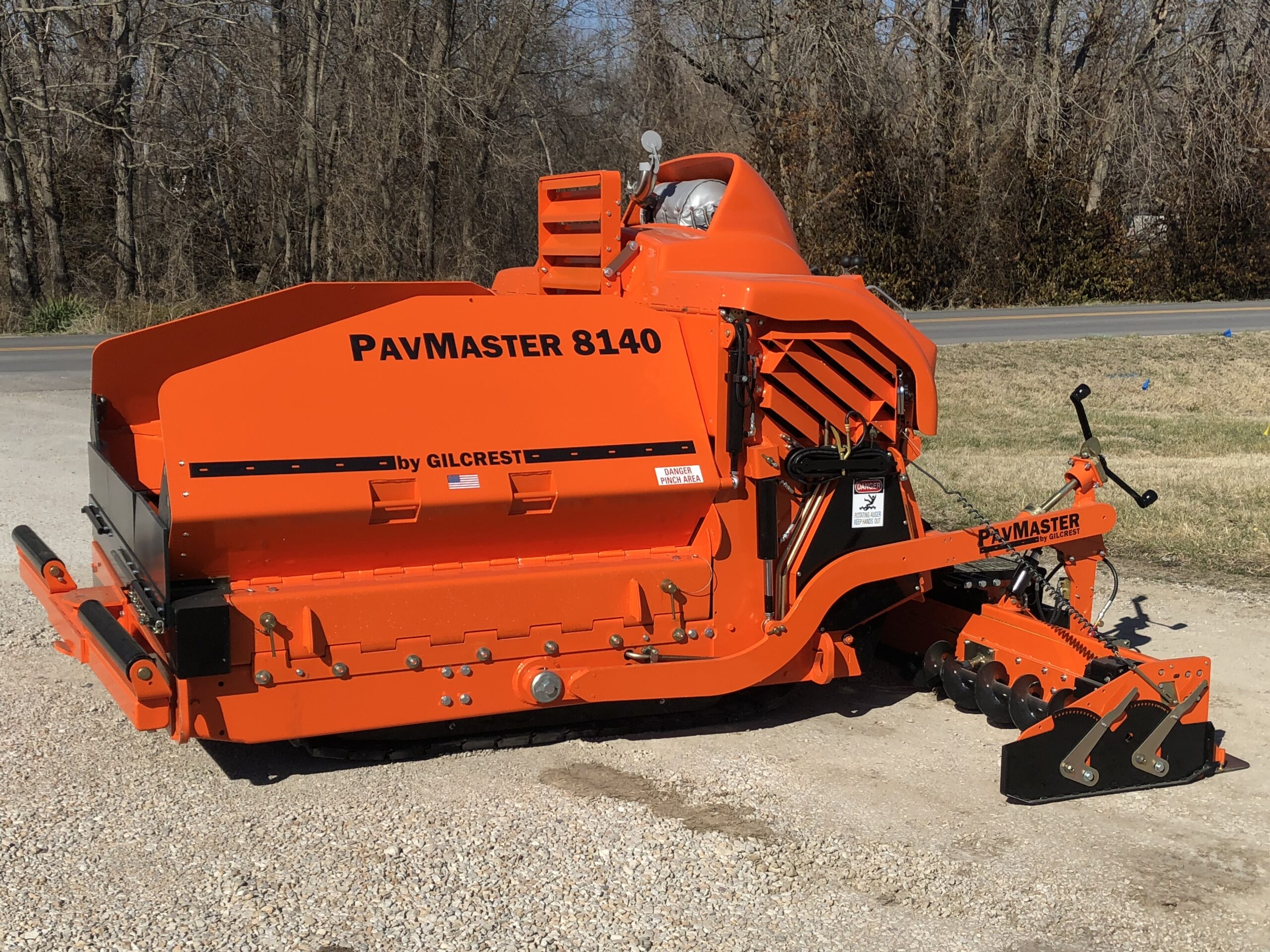 A large orange machine positioned on the ground, showcasing its vibrant color and industrial design.