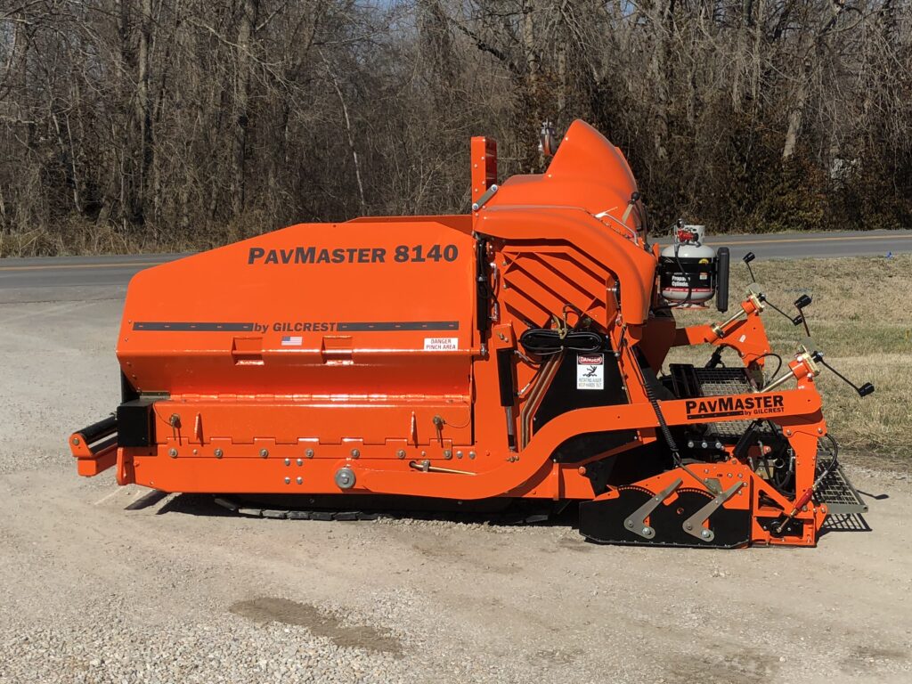 An imposing orange machine resting on the ground, highlighting its size and striking hue.