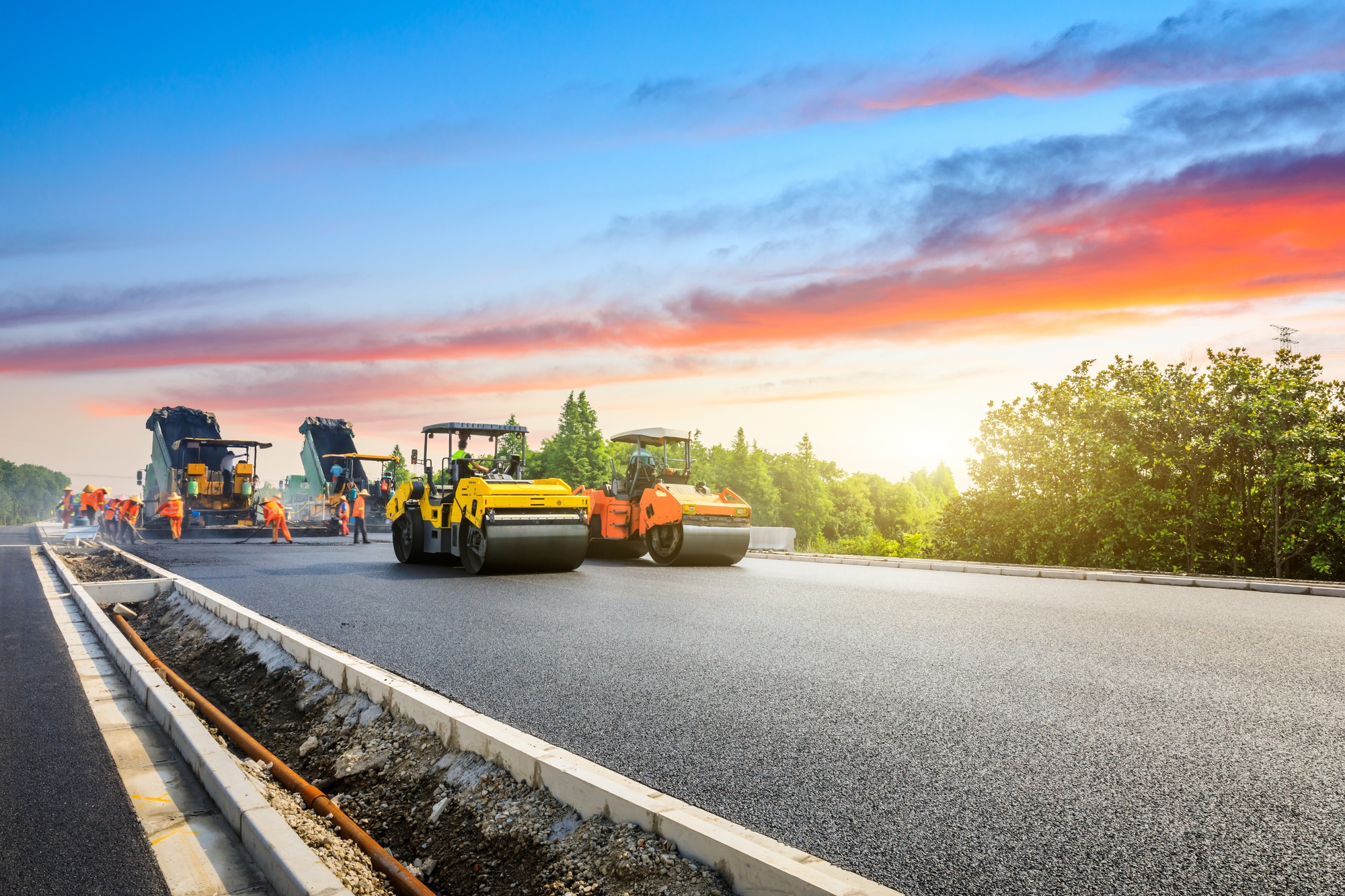 Construction site is laying new asphalt road pavement,road construction workers and road construction machinery scene.highway construction site landscape.; Shutterstock ID 1679316856; purchase_order: Limited 7.26.21